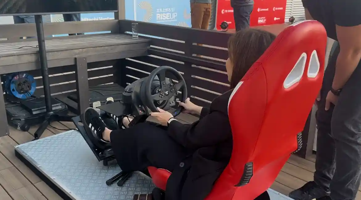 Visitor trying the racing simulator at a motor show