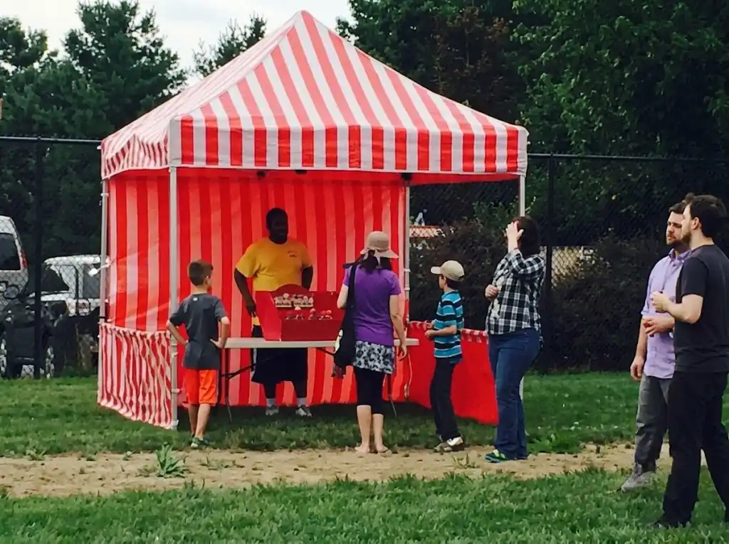 Red and white striped funfair stall hire at a corporate party