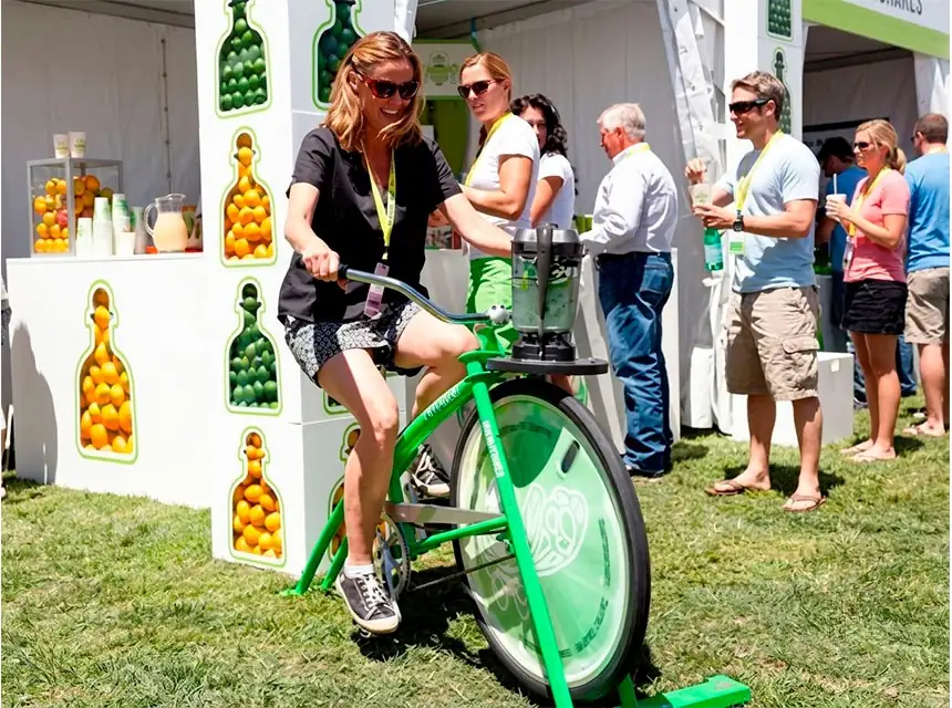 Employees pedalling the smoothie bike at a company event