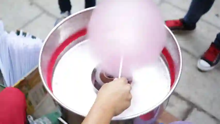 Operator spinning candyfloss at a town festival