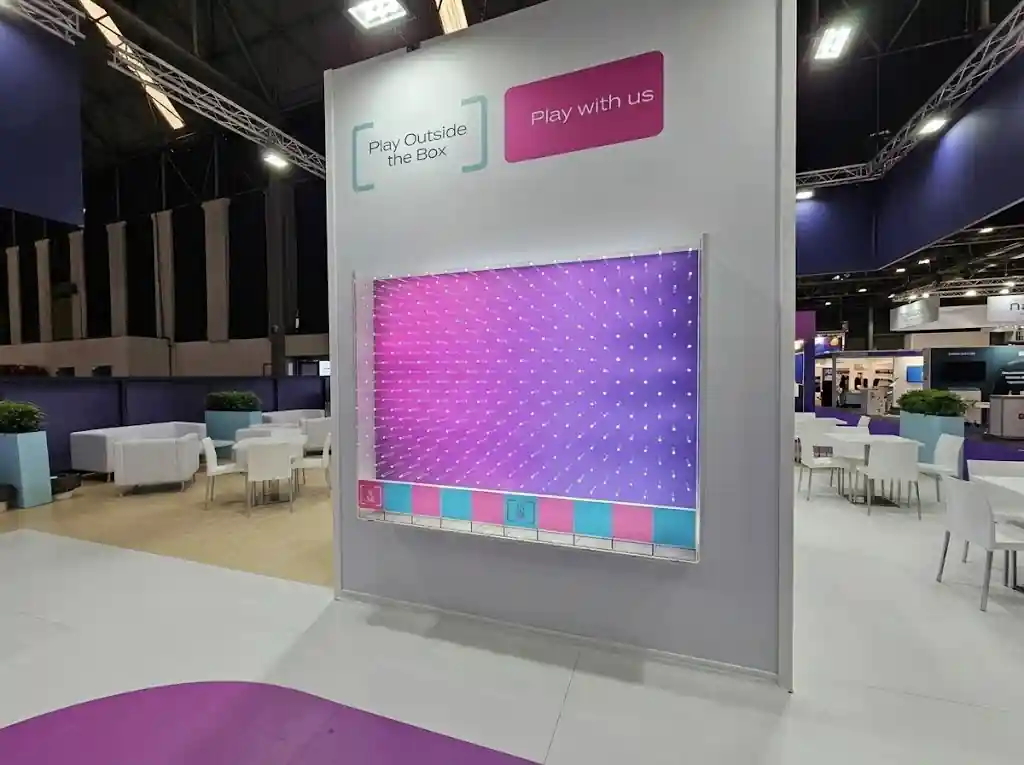 Guest dropping a disc on a giant Plinko at an event