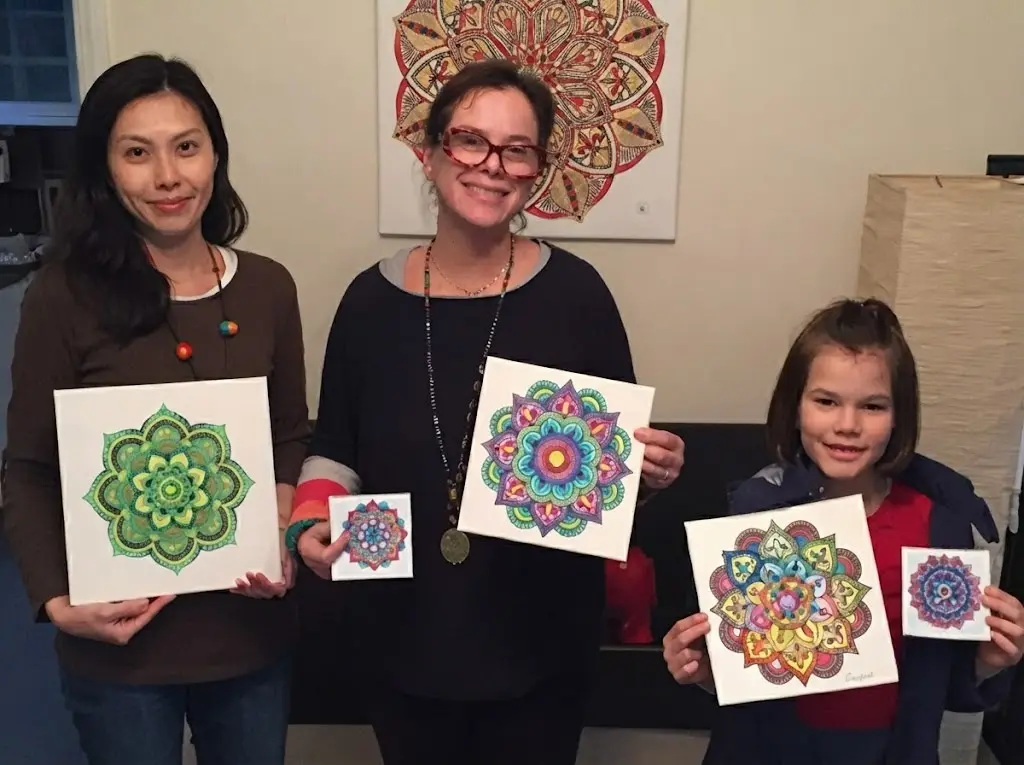 Adults drawing spirograph mandalas at a company event