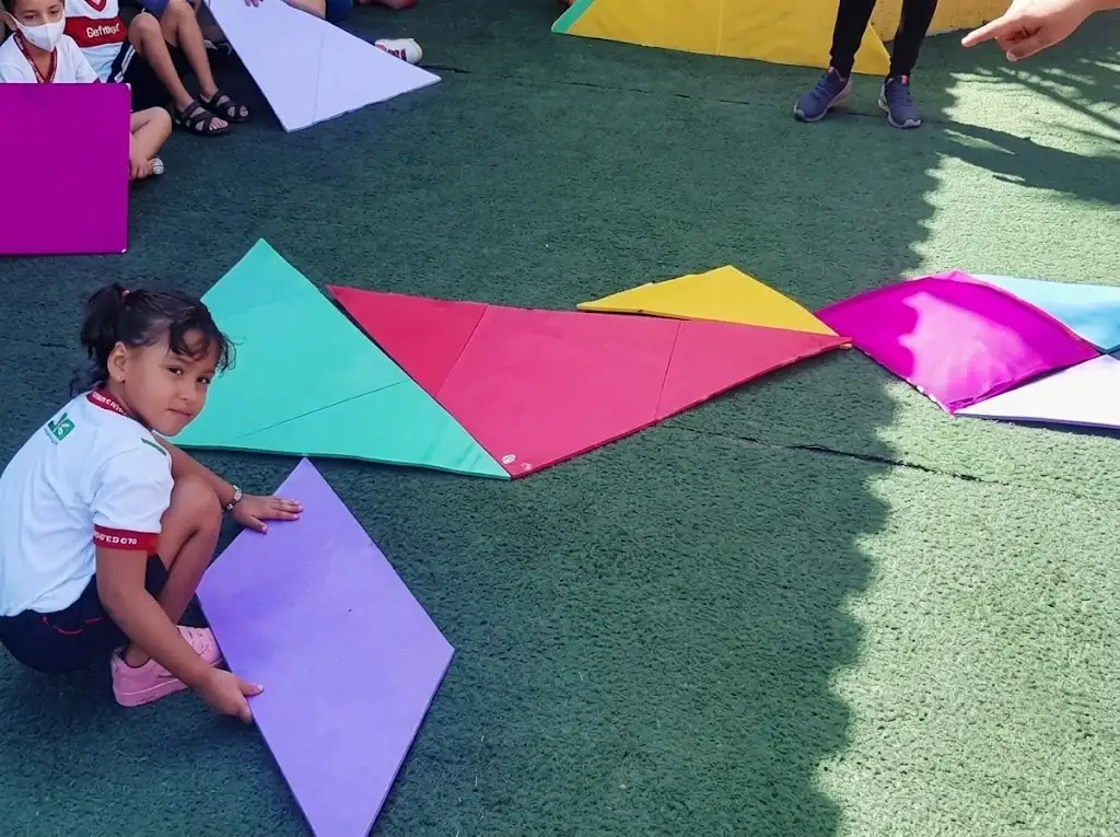 Families playing giant tangram at a family day