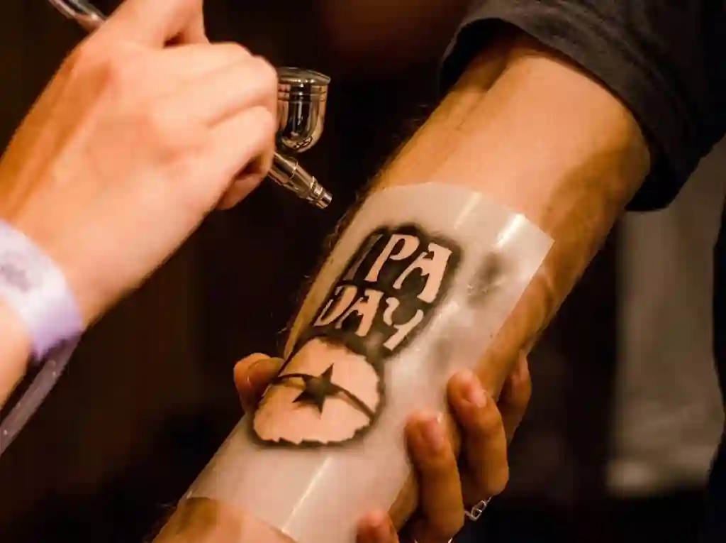 Airbrush temporary tattoo on a trade fair stand