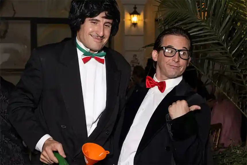 Guests laughing with a comic waiter at a wedding