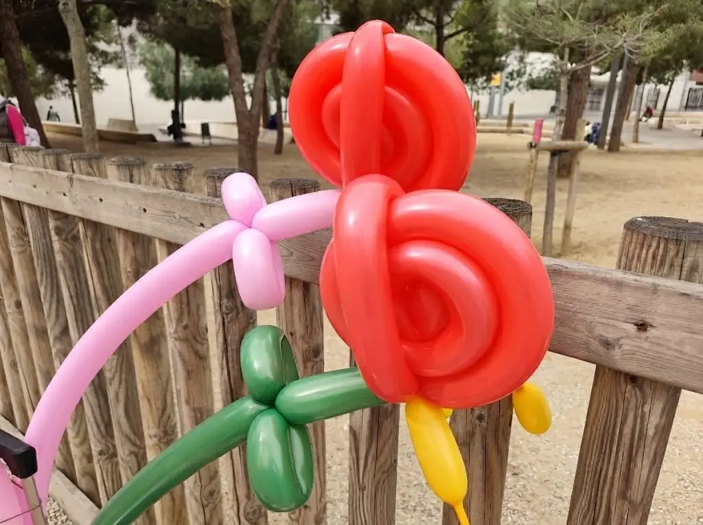 Instructor teaching balloon modelling to children at a wedding
