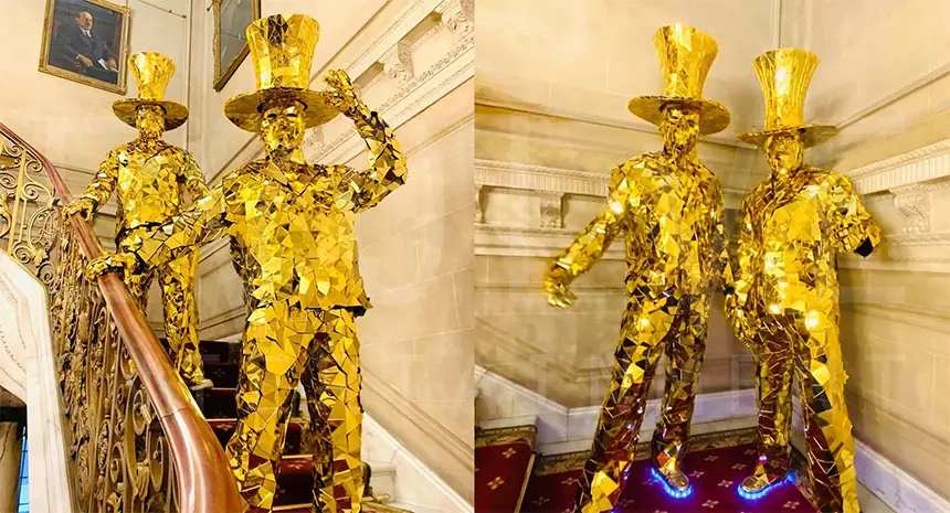 Golden stilt walker at a company anniversary party