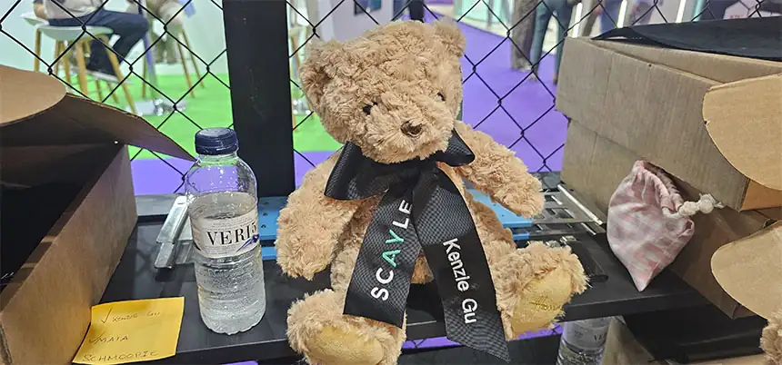 Visitor receiving a teddy bear with their name as a promotional gift