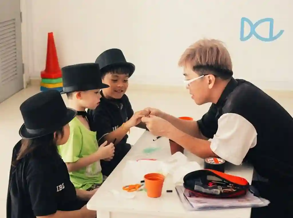 Children practising tricks at a family day magic workshop