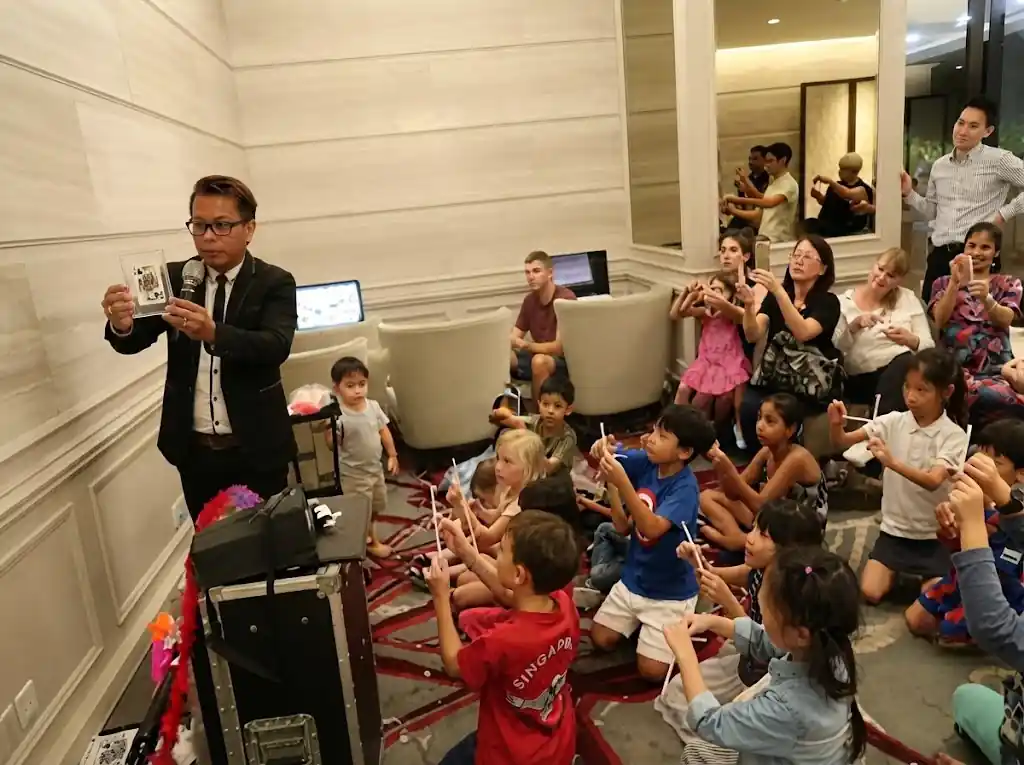 Magician teaching card tricks at a magic workshop for companies