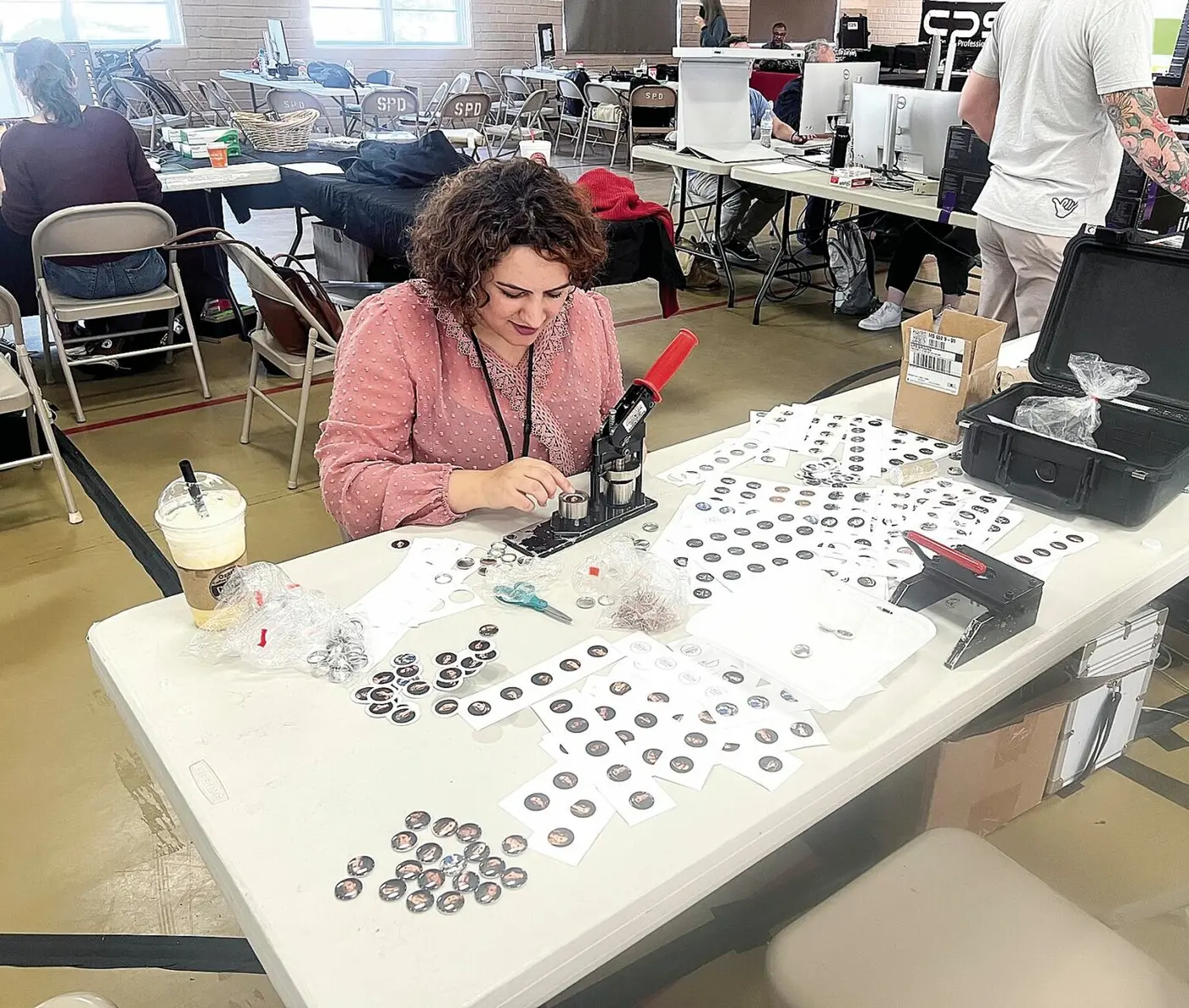 Children designing badges at a company family day