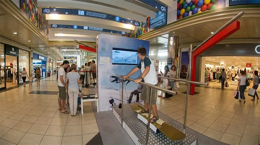 Snowboard simulator on a sports brand stand