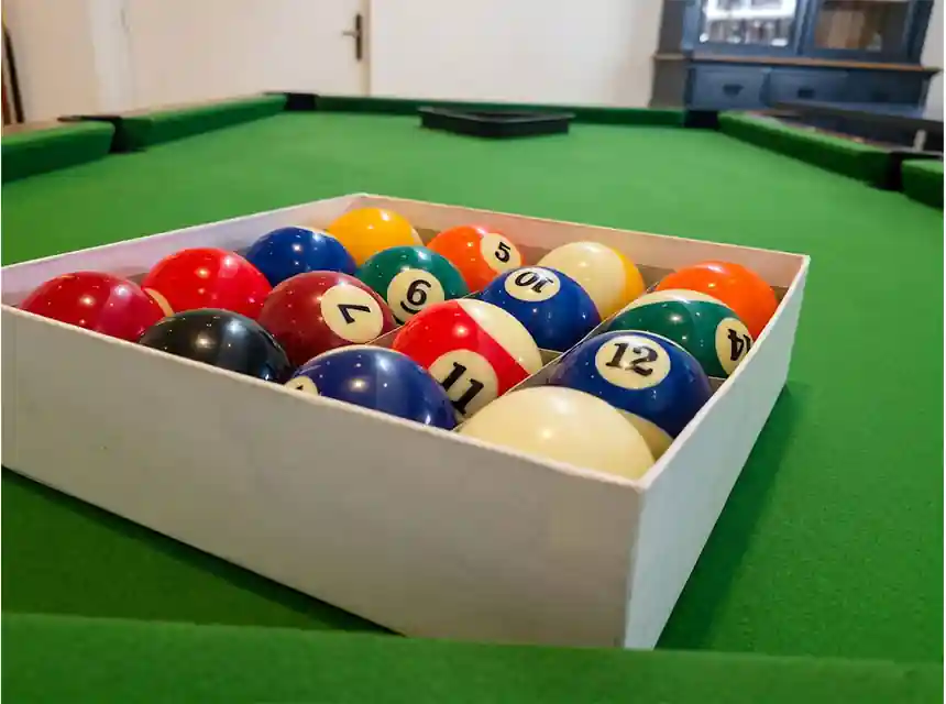 Guests playing American pool at a company Christmas party