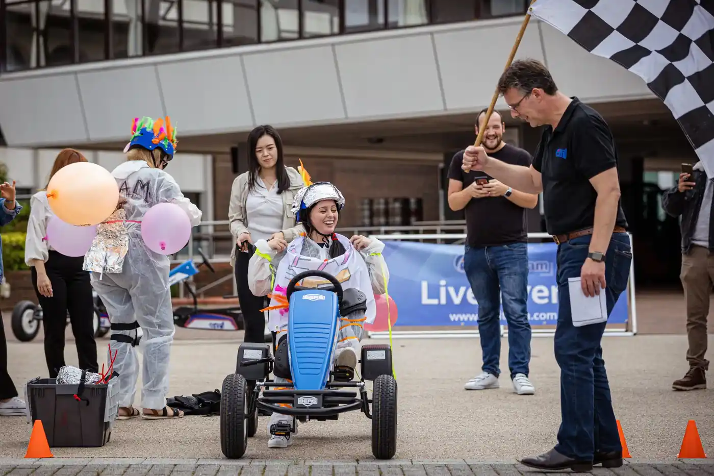Employees racing in a company go-kart event