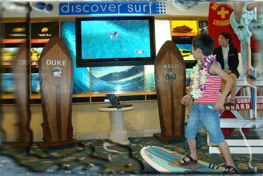 Girl trying the surf simulator at a children’s party