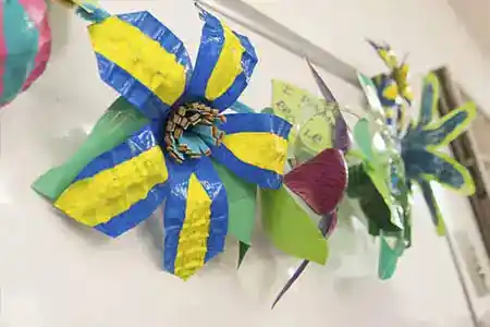 Children creating art with recycled bottles at a family day