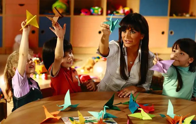 Children making origami figures at a wedding