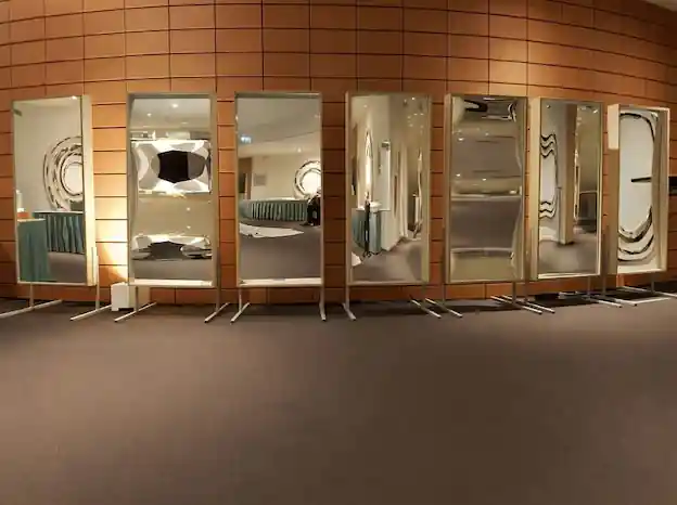 Guests laughing in front of the distorting mirrors at a company dinner