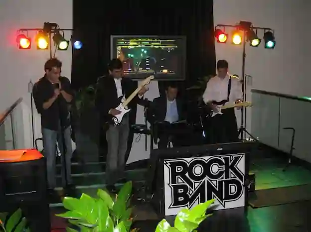 Colleagues playing guitar and drums at a corporate party