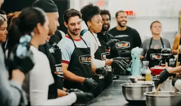 Colleagues plating dishes at a food team building