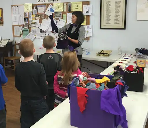 Children making puppets at a company family day in Barcelona