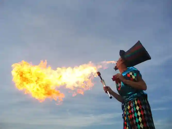 Fire stilt walker juggling at a night-time wedding